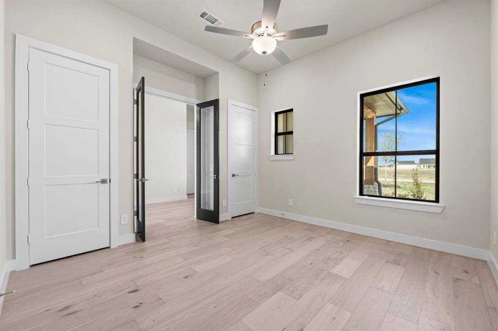 The Study/Home Office with Double Doors, 2 Storage Closets, and Fan.