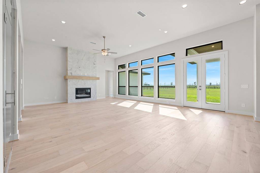 Family Room with Natural Light and Gas Fireplace with Floating Mantel and Tile to the Ceiling