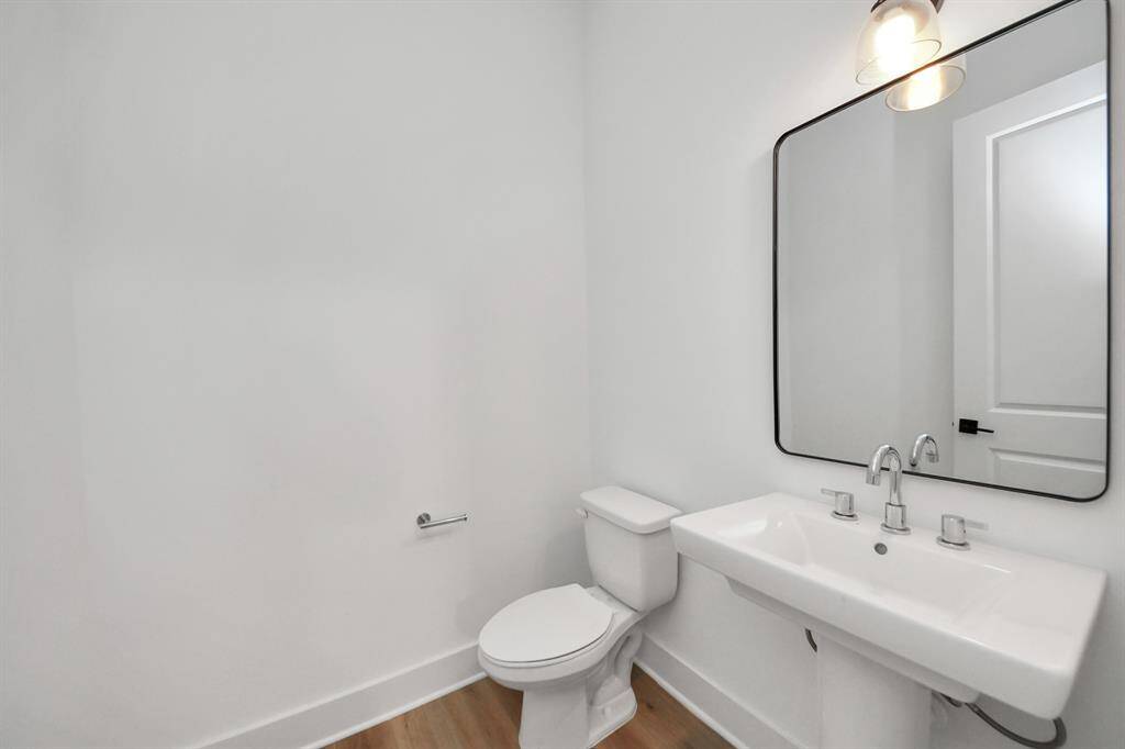 The half bath is located on the second floor, right off the kitchen/dining area for convenience.
