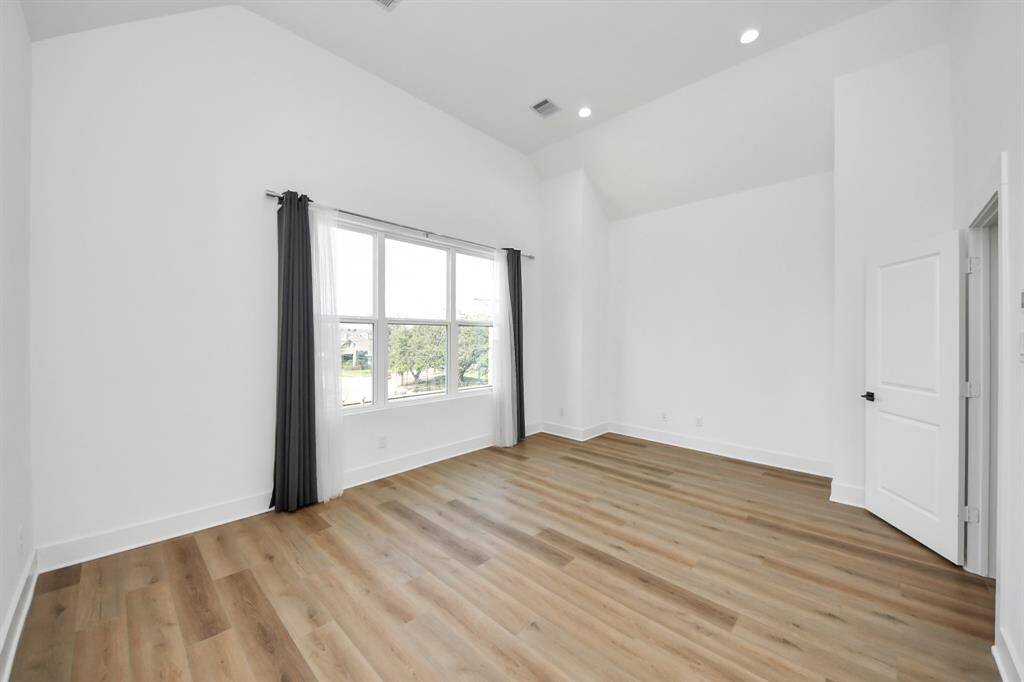 Talk about the perfect primary suite to come home to from a long day after work! This stunning primary bedroom features large windows, ample natural light, cathedral ceilings, extra space for seating or TV console. *This photo is virtually staged