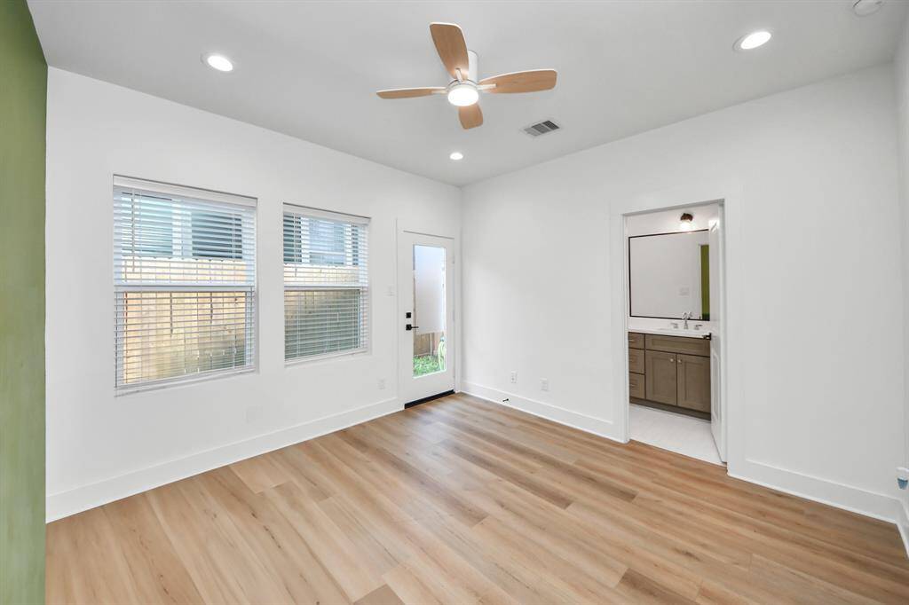 Tucked away on the first floor, this home office is perfect for privacy and productivity. It is also an en-suite secondary bedroom which is perfect for guests. This room has been upgraded with an accent wall and ceiling fan, with easy access to the backyard.