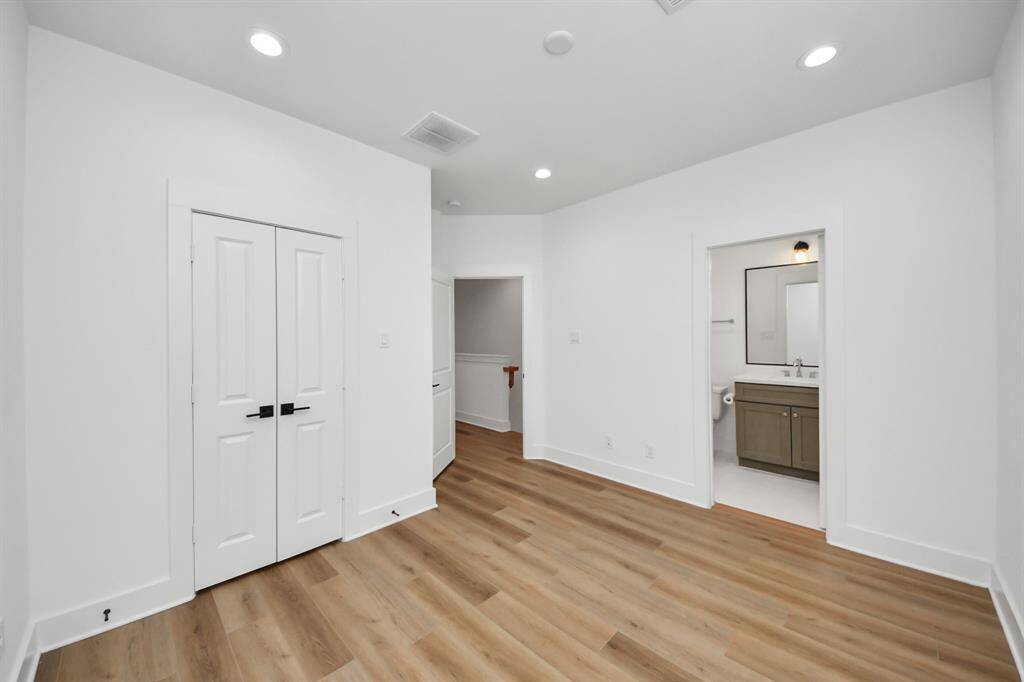 The secondary bedroom is filled with natural light and located on the opposite side of the primary suite to maximize privacy.