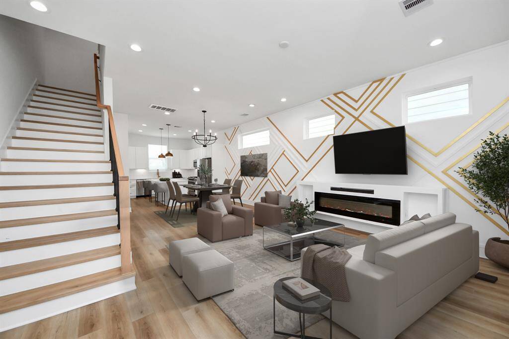 Impress your family and guests in this beautiful living/dining open-concept room! Featuring high ceilings, recessed lighting, gorgeous luxury vinyl floor, stylish light fixtures, and a jaw-dropping custom LED accent wall. Beautiful windows to fill the room with natural light throughout the day. *Photo is virtually staged.