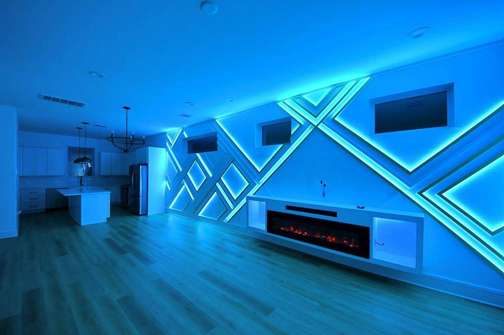 Entertain in style! Living room features a custom LED accent wall with built-in electric fireplace and sound bar. You can easily control the lights on your phone and it comes with multiple settings/colors.