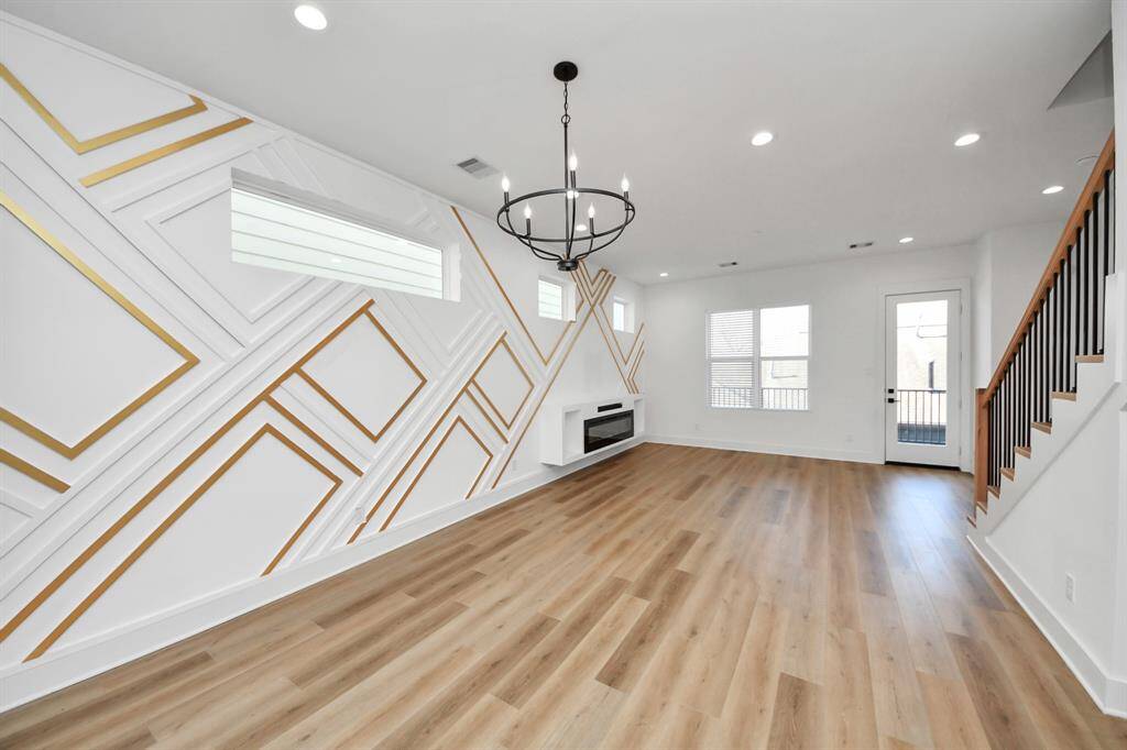 The open-concept living/dining/kitchen/covered balcony is perfect for entertaining, host dinners, or just relaxing in. The custom accent LED wall features multiple mood lighting options for ambience. This space also features an electric fireplace with sound bar included, luxury vinyl flooring, and easy access to a large covered balcony.