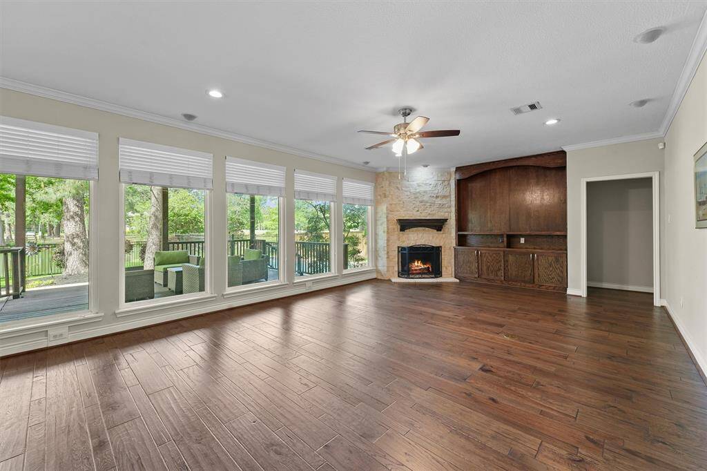 A cozy fireplace and a wall of windows in the first floor living room.  All windows are double pane.