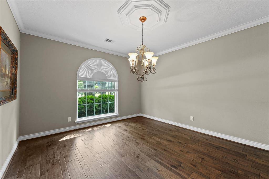 Wood floors continue into the dining room.