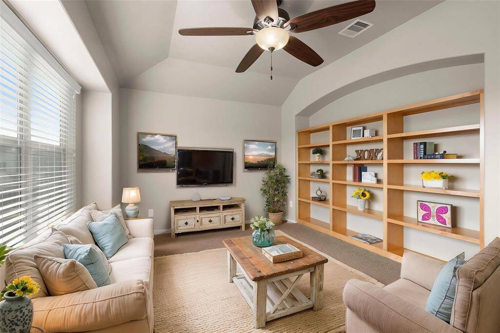 Upstairs game room offers lovely built-in bookshelves for all of those books/games, and a little privacy and noise reduction from the downstairs. Notice another box seat window... the natural light in this home is lovely.