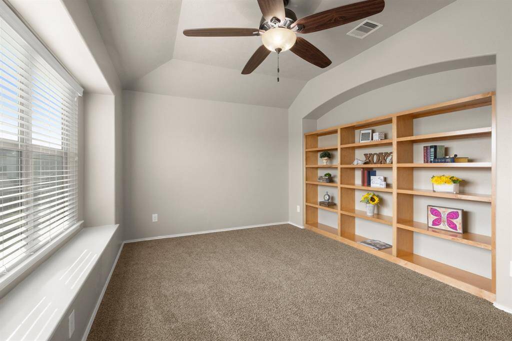 Upstairs game room offers lovely built-in bookshelves for all of those books/games, and a little privacy and noise reduction from the downstairs. Notice another box seat window... the natural light in this home is lovely.