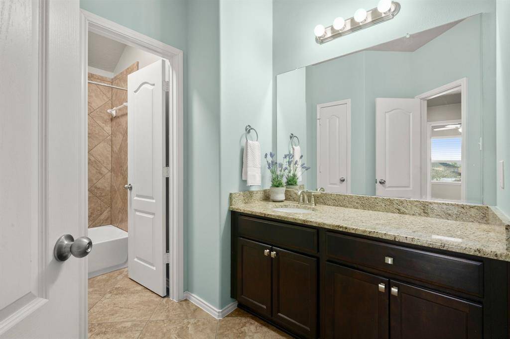 Bath 2 provides a privacy door between the tub/shower/toilet and the vanity area. Linen closet and plenty of cabinets and counters. Granite tops, under-mount sink, satin chrome finishes, a large mirror, and a crisp designer paint top off this secondary bath.