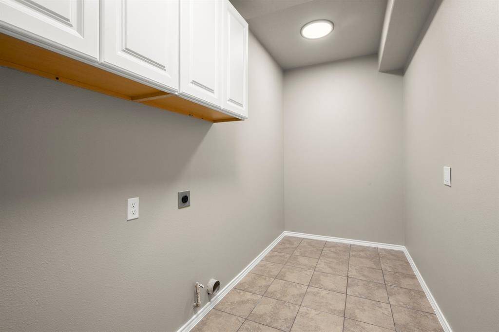 HUGE laundry room was expanded - great spot for a fridge or add a mud bench. Storage cabinets and bright lighting make this remodel a great addition.