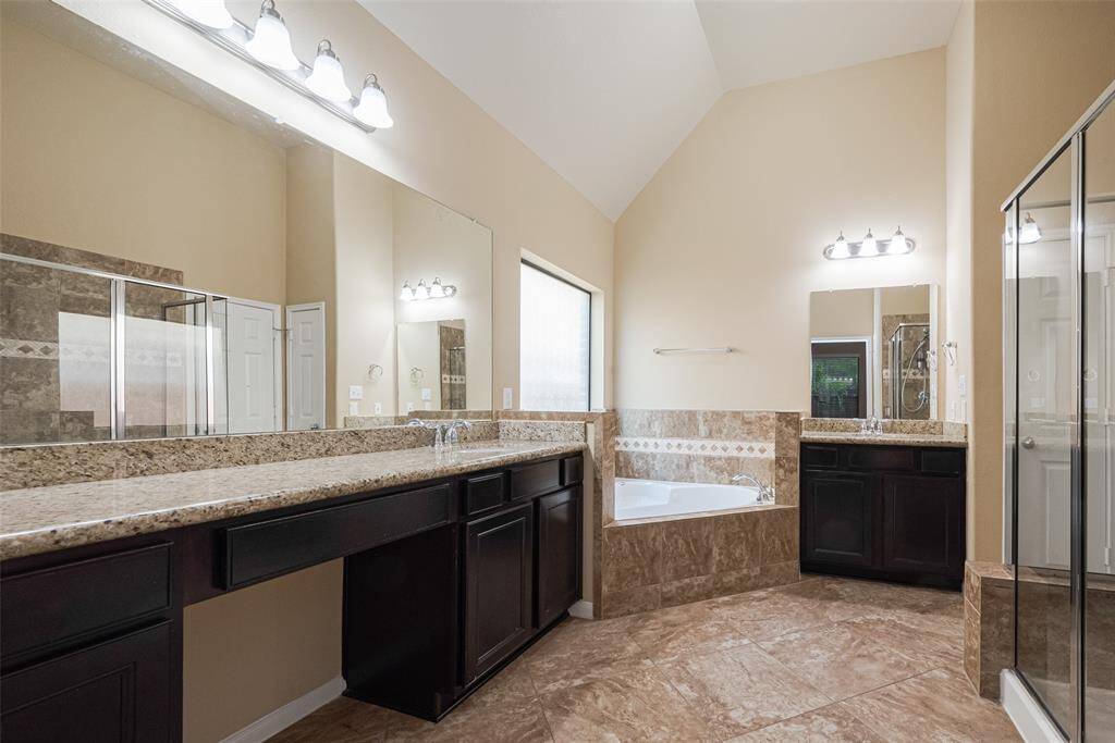 Primary bathroom with dual vanities, elegant finishes and so much space! JETTED jacuzzi style tub plus walk-in shower