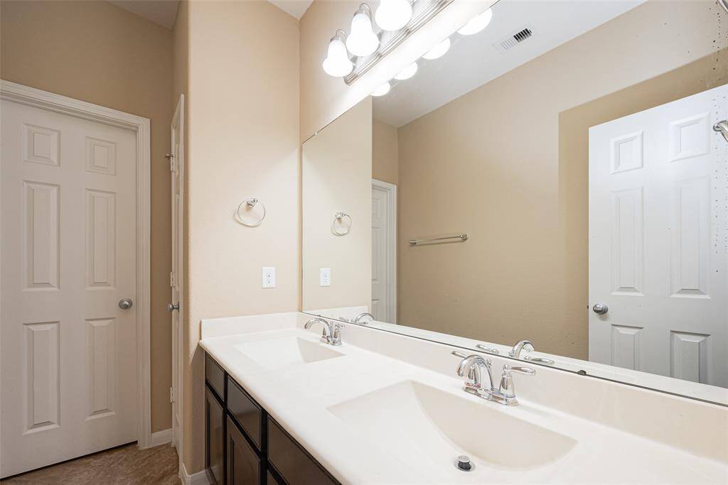 3rd full bath! Double-sink vanity in secondary bath with updated fixtures