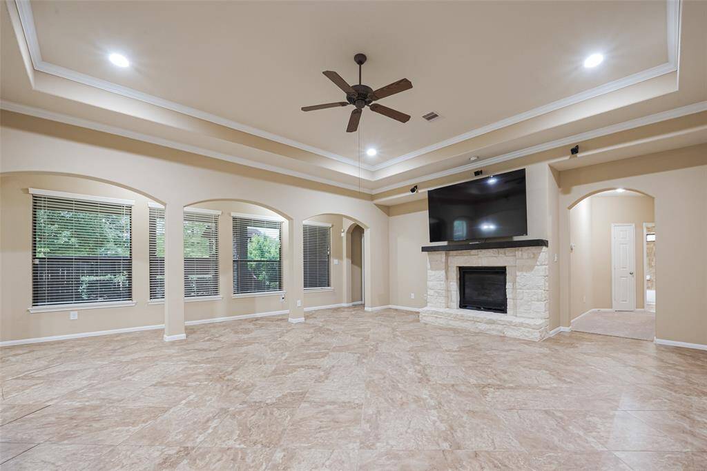 Secondary living or flex space with rich flooring and neutral tones