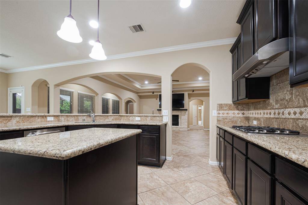 Open sightlines from living room to kitchen and breakfast area- perfect for cooking and entertaining while being included in the fun!