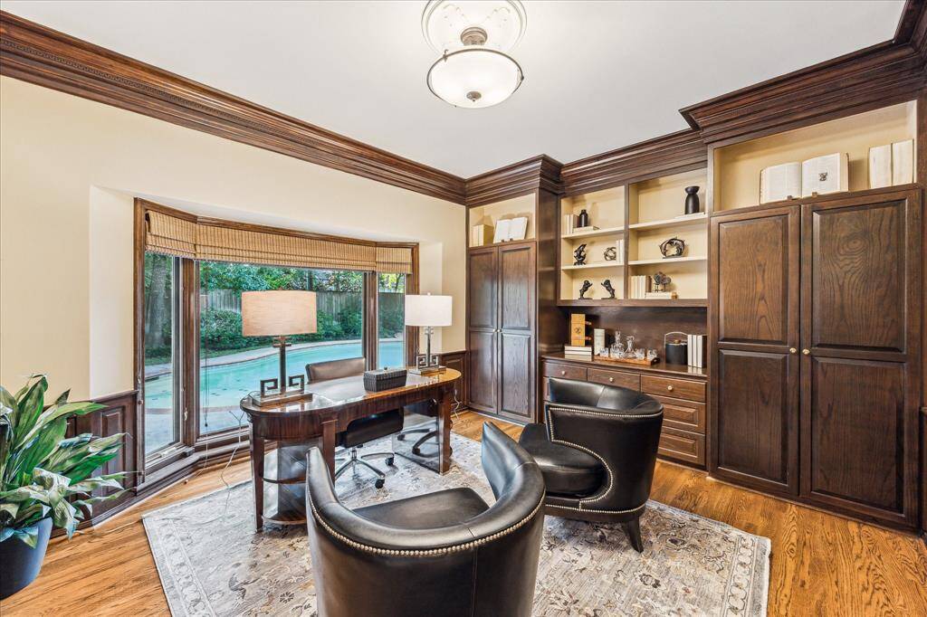 First floor study with bay window overlooking the pool. A wall of storage and bookshelves, with a closet