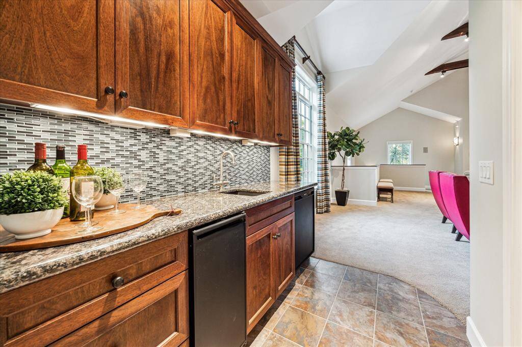 Wet bar in the game room with bar refrigerator and ice maker