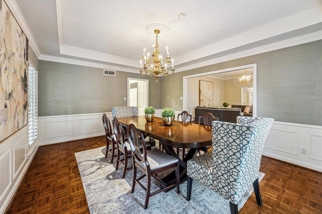Dining room with recessed ceiling, parquet floors and wainscoting
