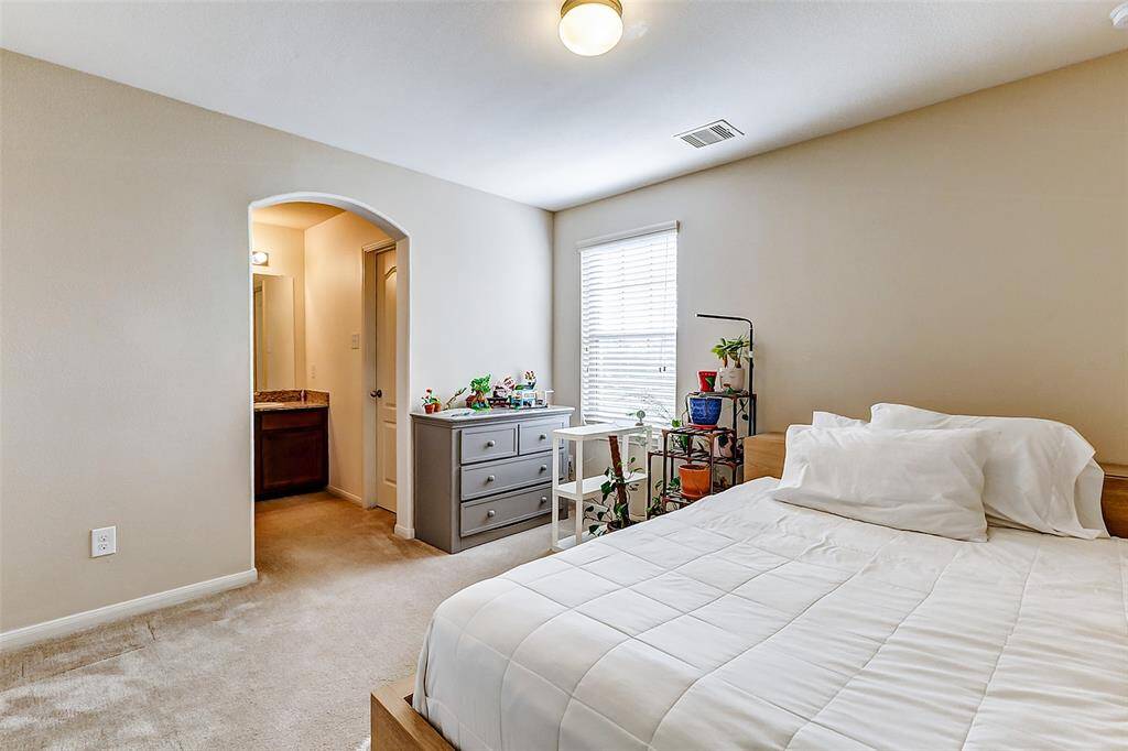 A peaceful bedroom with a cozy ambiance, neutral tones, and a private ensuite bath.