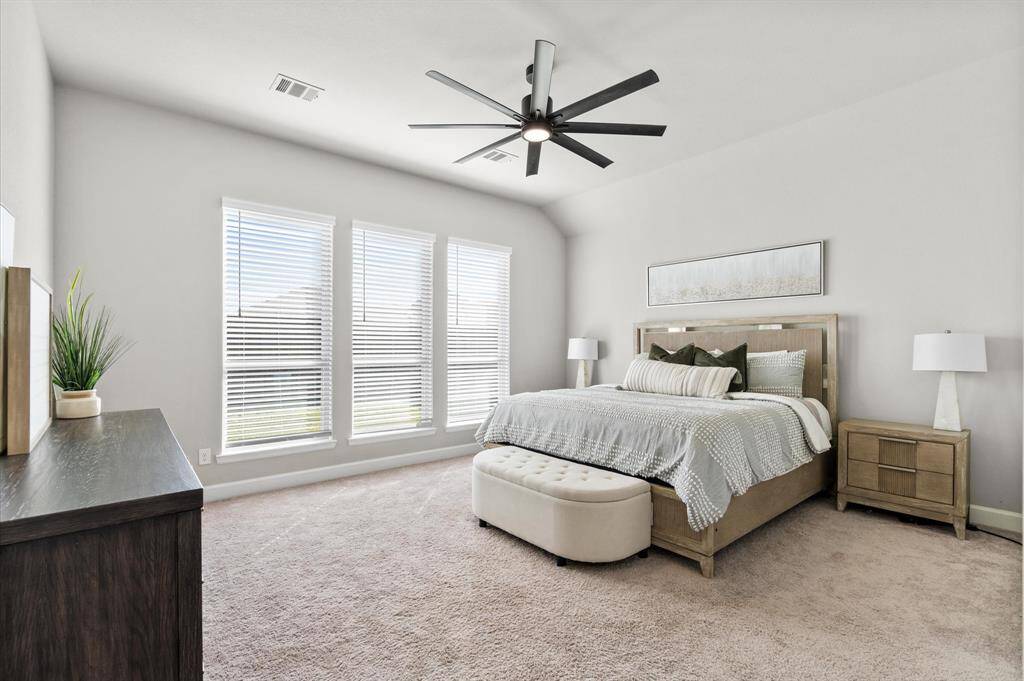 Stunning primary bedroom with upgraded ceiling fan.