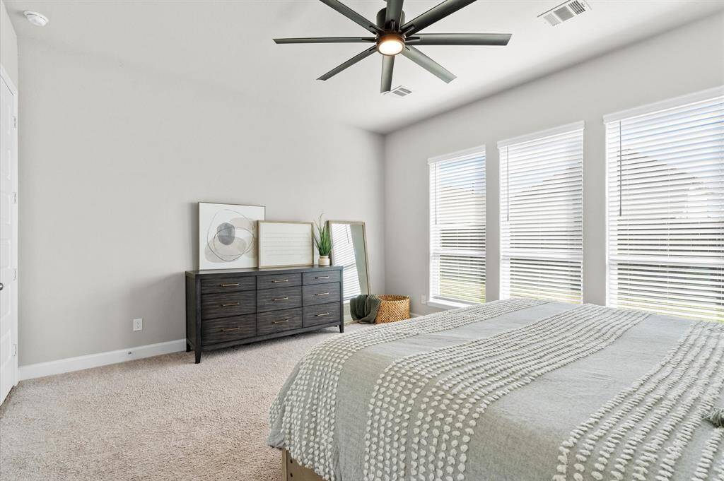 Primary bedroom has plenty of space for a reading nook.
