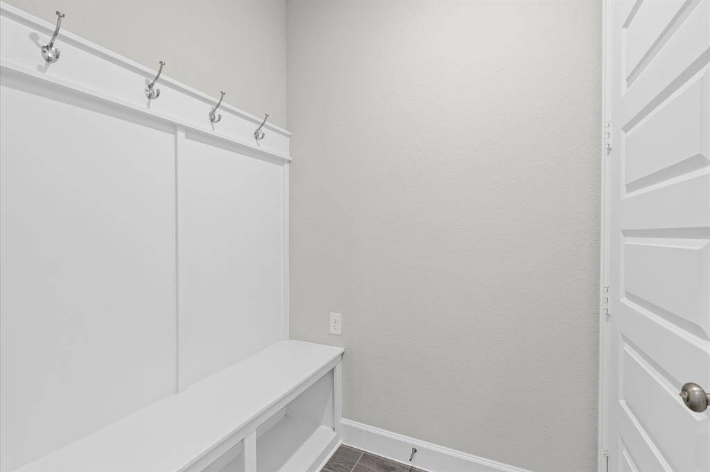 MUD room adjacent to garage has everyone covered.