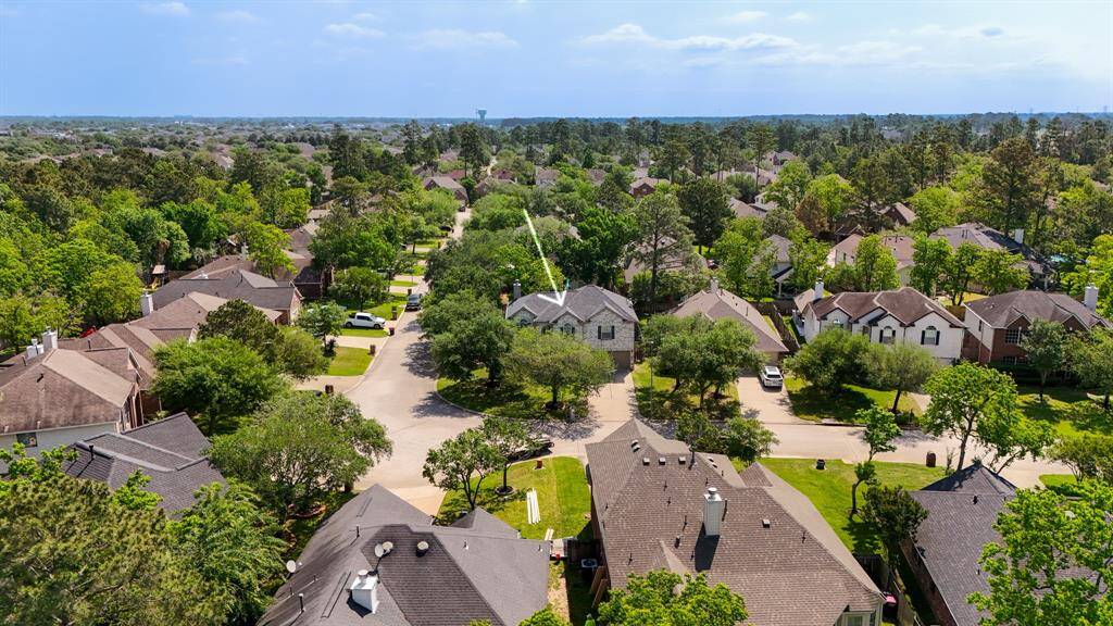 This aerial view showcases the home's prime corner lot location in Windrose, just moments from community amenities including two pools, tennis and pickleball courts, walking trails, and serene fishing lakes.