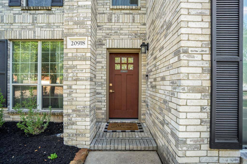 Welcome home! A welcoming approach to the front porch of this charming two-story home, offering a perfect spot to relax and enjoy the neighborhood.