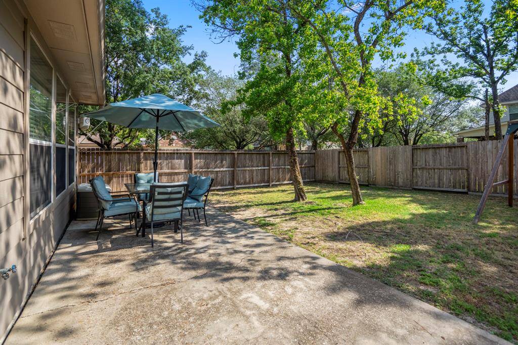 Stepping out the back door, you'll find an extended patio, perfect for outdoor dining, entertaining, or relaxing while enjoying the spacious backyard.