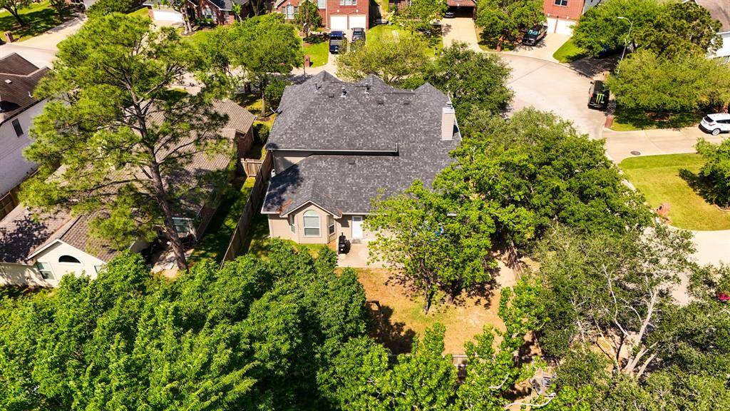 This aerial shot captures the full scope of the backyard, highlighting the ample space for outdoor activities, while offering a clear view of the home’s position on the corner lot within the community. It’s the perfect spot to relax or entertain, with plenty of room for a pool, garden, or play area.