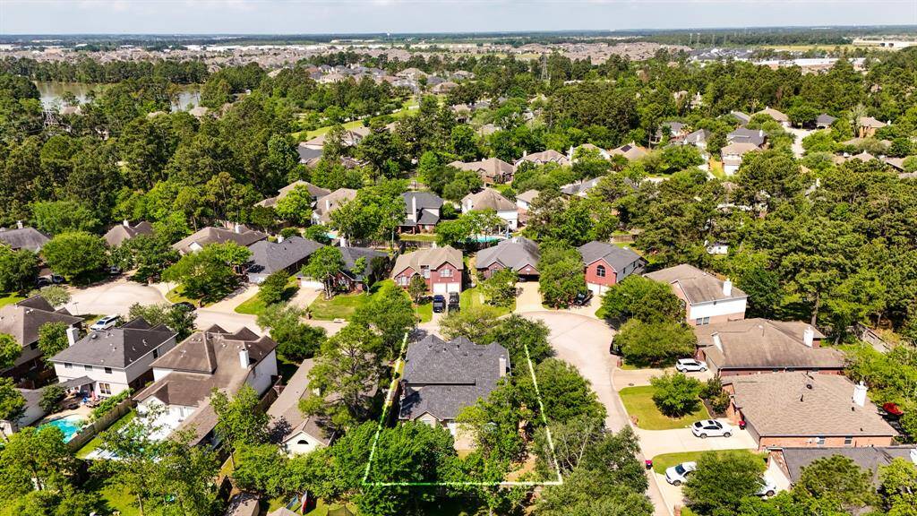 This aerial view captures the home’s prime corner lot location within Windrose, with the lush golf course visible in the distance. It offers a clear sense of space and proximity to the community's desirable amenities.