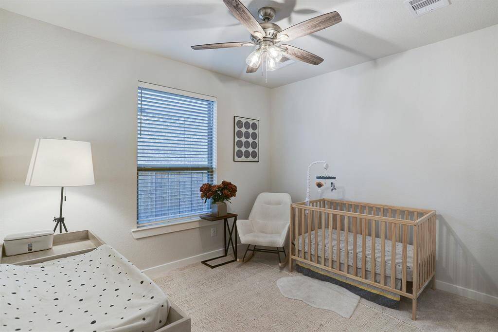 The 1st-floor secondary bedroom #1 is adjacent to the secondary full bath.