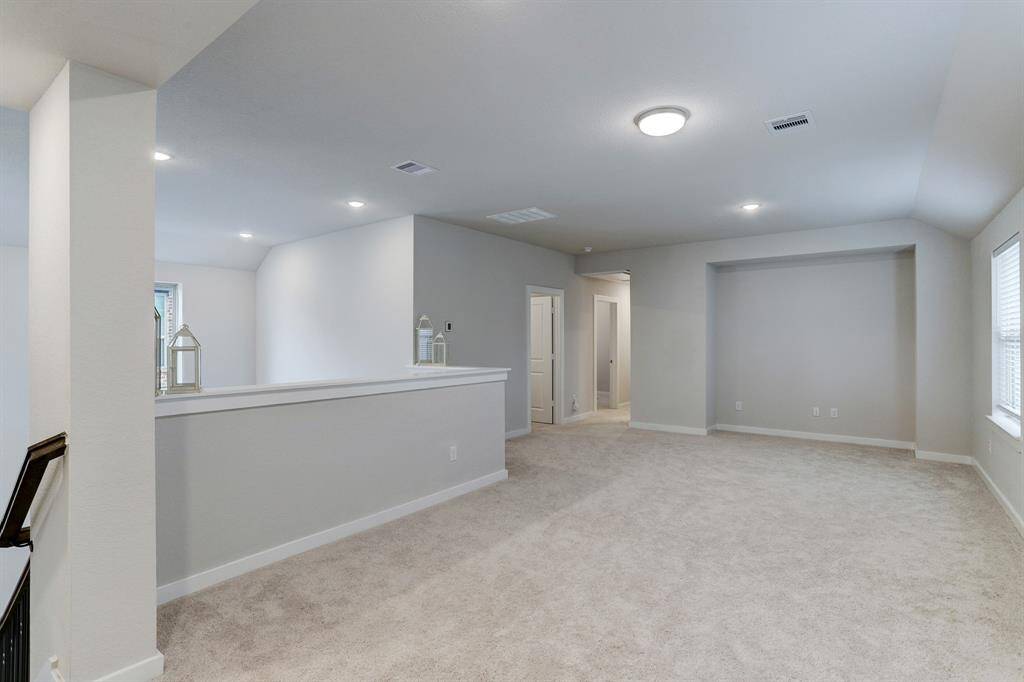 Upstairs is a generously sized game room that is ideal for lounging, entertaining, or work-from-home space.