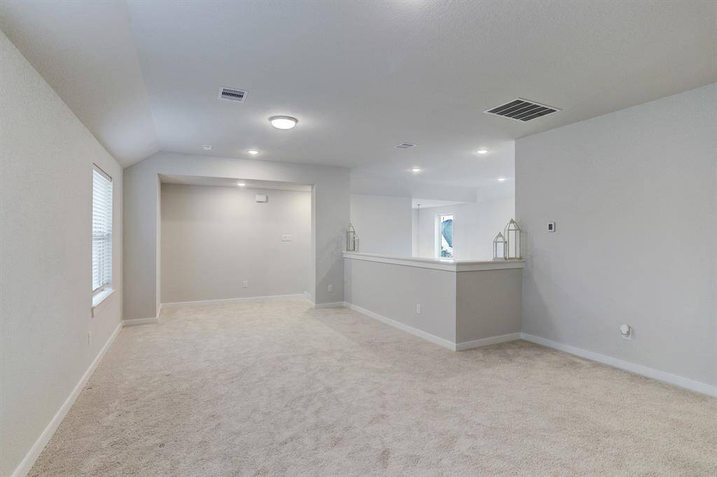 The generously sized upstairs game room offers access to the 2nd-floor secondary bedrooms and secondary full bath.