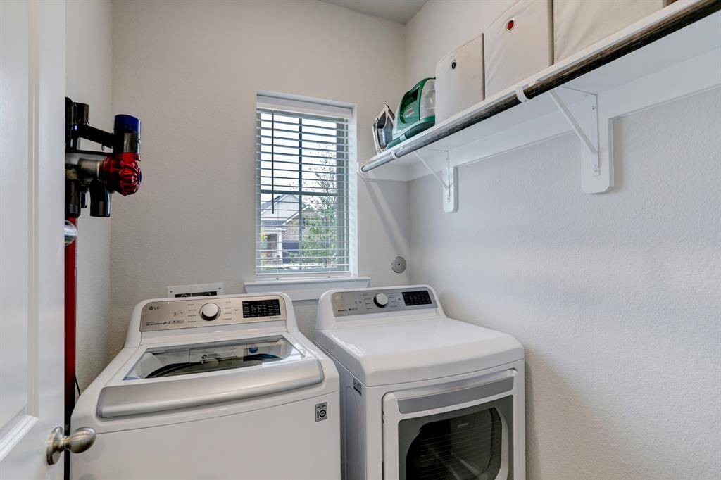 The 1st-floor utility room is adjacent to the 2-car attached garage. Washer and dryer included in sale of home.