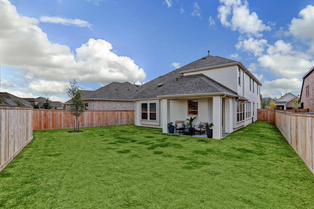 The large fenced-in back yard features an automatic sprinkler system allowing for easy lawn maintenance.