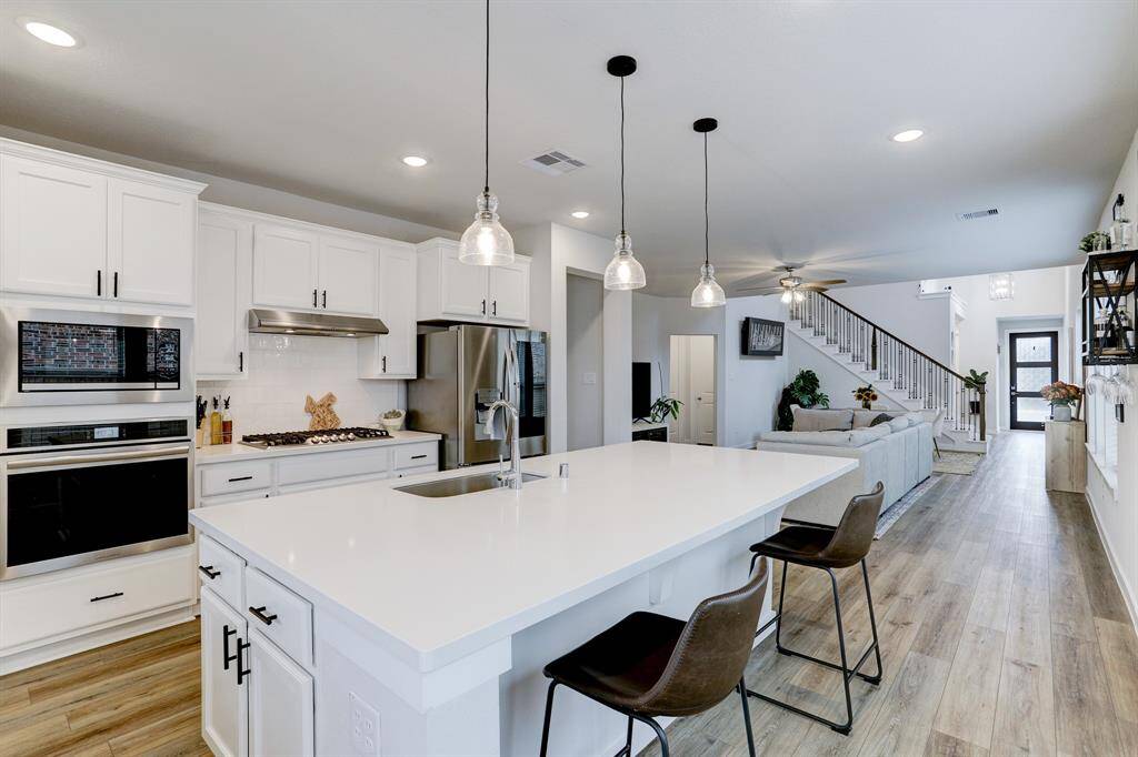 Stylish and durable quartz counters allow for easy maintenance. Kitchen includes Frigidaire stainless steel appliances. Refrigerator included in sale of home.