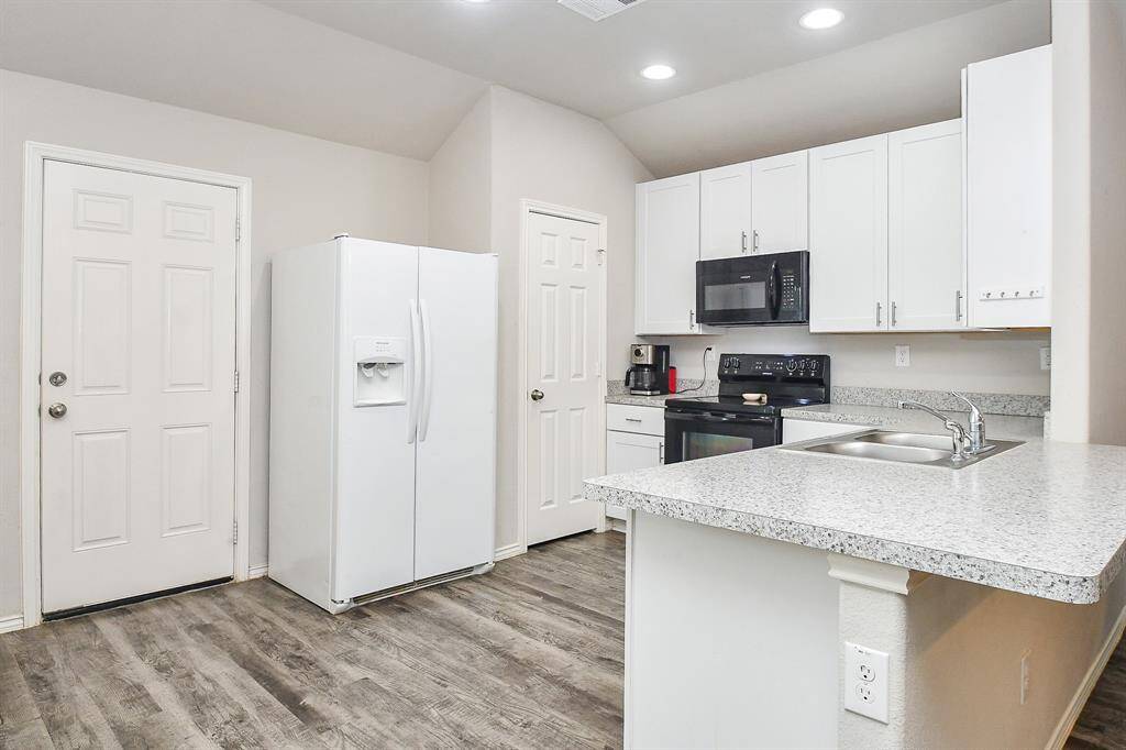 The Kitchen has a Breakfast Bar, Breakfast Room & a Large Pantry & is Open to the Living Area. The Door leads to the Approx. 10x14 Covered Backyard Patio and Large Backyard. The Refrigerator is Included!