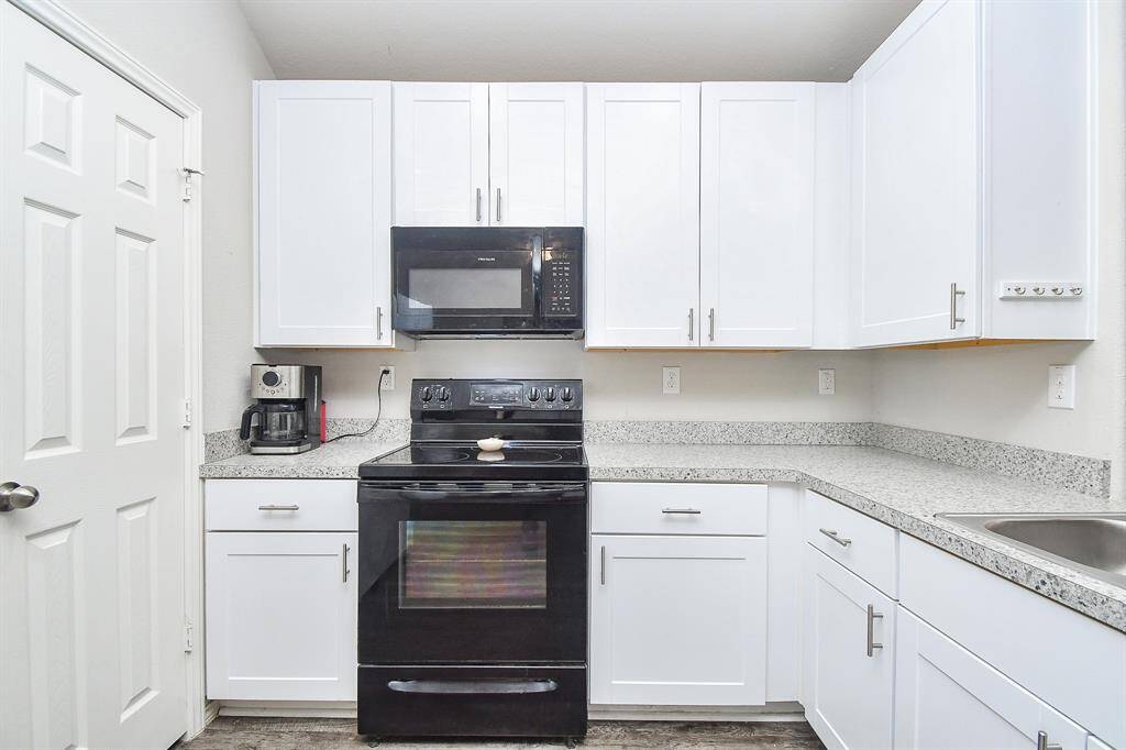 The Kitchen has a Breakfast Bar, Breakfast Room & a Large Pantry & is Open to the Living Area.