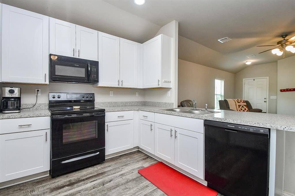 The Kitchen has a Breakfast Bar, Breakfast Room & a Large Pantry & is Open to the Living Area.