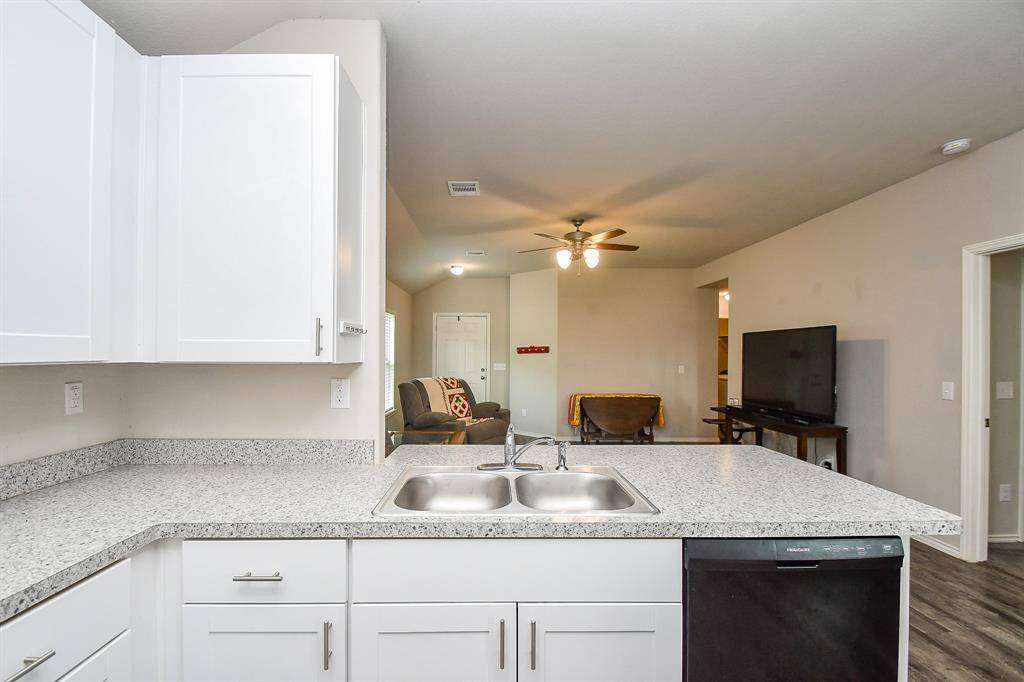 The Kitchen has a Breakfast Bar, Breakfast Room & a Large Pantry & is Open to the Living Area.