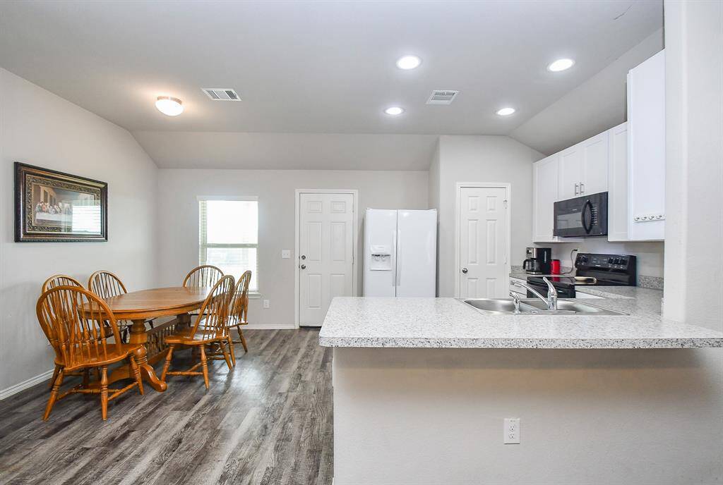 The Kitchen has a Breakfast Bar, Breakfast Room & a Large Pantry & is Open to the Living Area. The Door leads to the Approx. 10x14 Covered Backyard Patio and Large Backyard. The Refrigerator is Included!