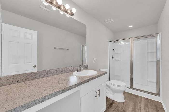 The En-Suite Primary Bath with Large Shower & Vanity Area. The Shower has Neutral Colored Tile Walls (not shown).