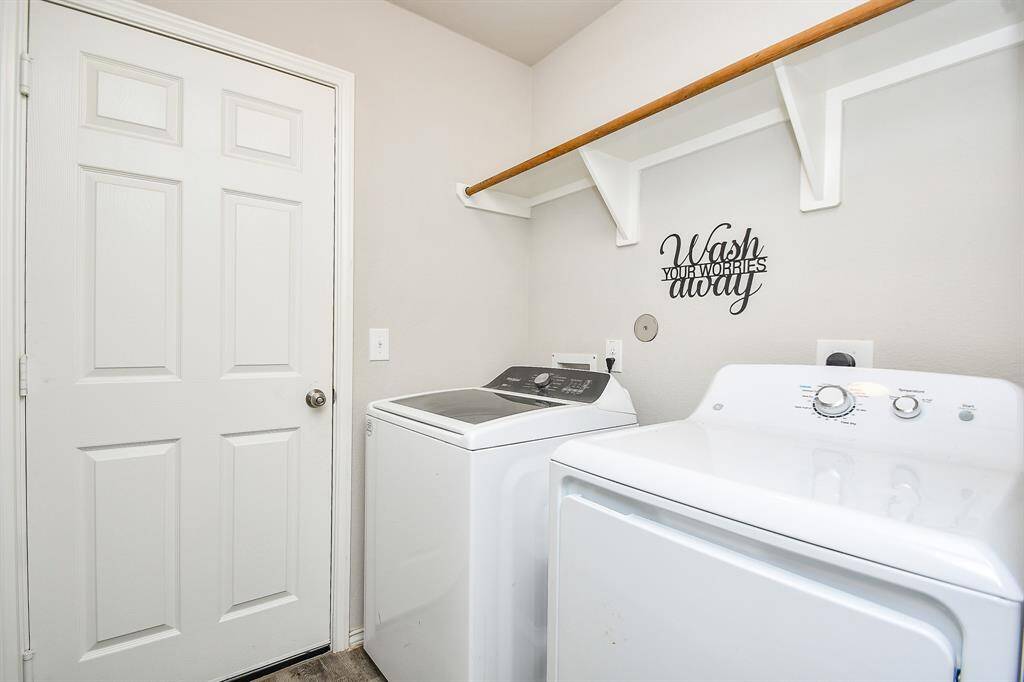 Utility Room with a Hanging Rod & Built-In Shelf accommodates a Full-Size Washer & Dryer Connects to the approx. 19ft wide x 20ft long Attached 2-Car Garage.