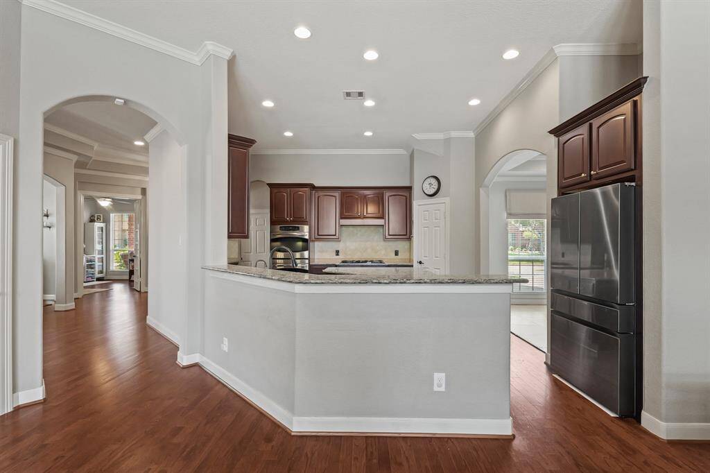 The open-concept layout flows seamlessly from the kitchen into the living and dining areas.