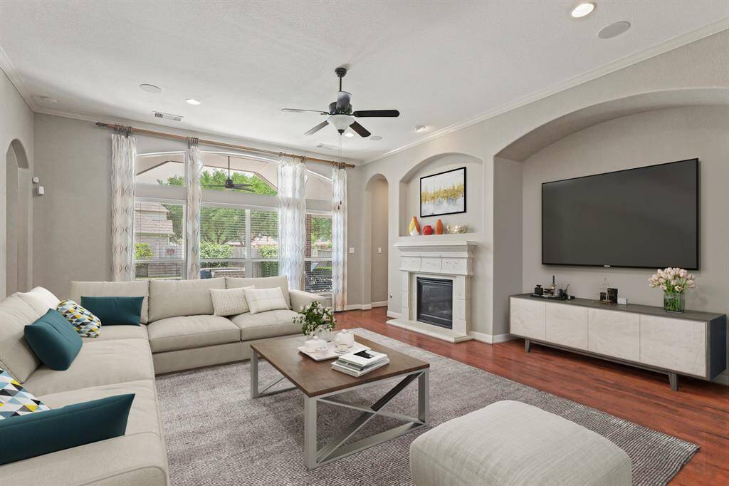 Virtually Staged: This stunning living room features recessed lighting and wood floors, gorgeous fireplace, and TONS of natural light.