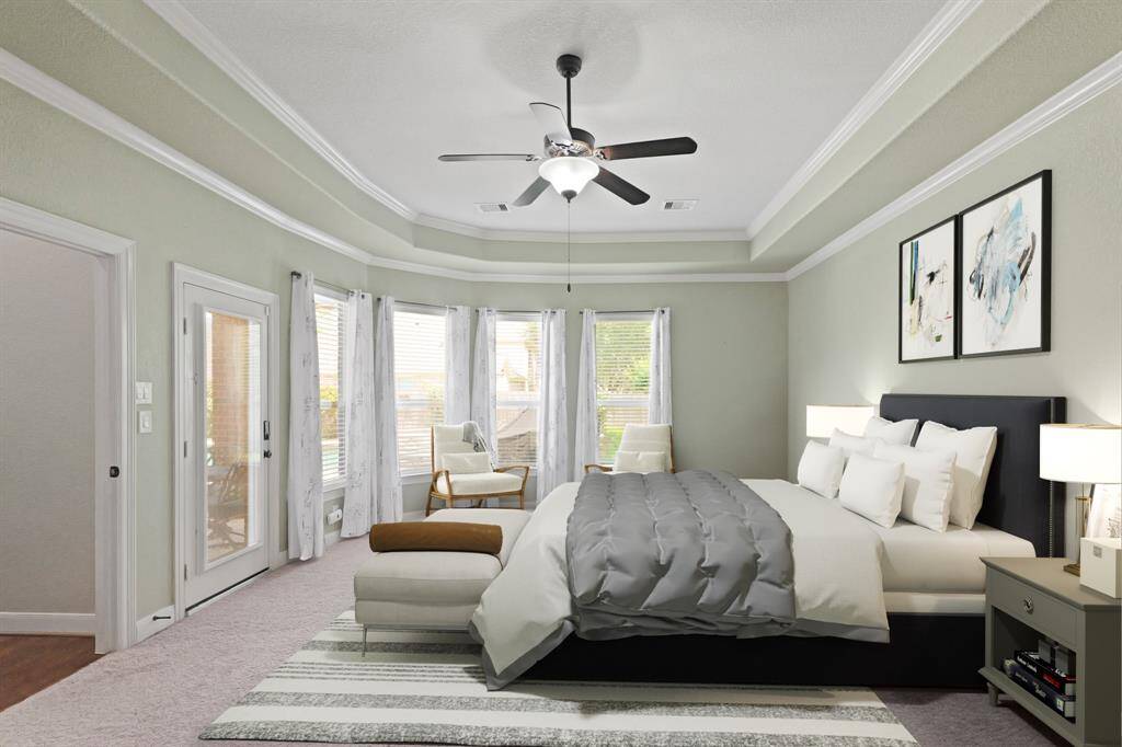 Virtually Staged: Unwind after a long day in this incredible Primary Bedroom! Featuring lots of natural light, carpet floors, a beautiful tray ceiling with fan, and crown molding details.