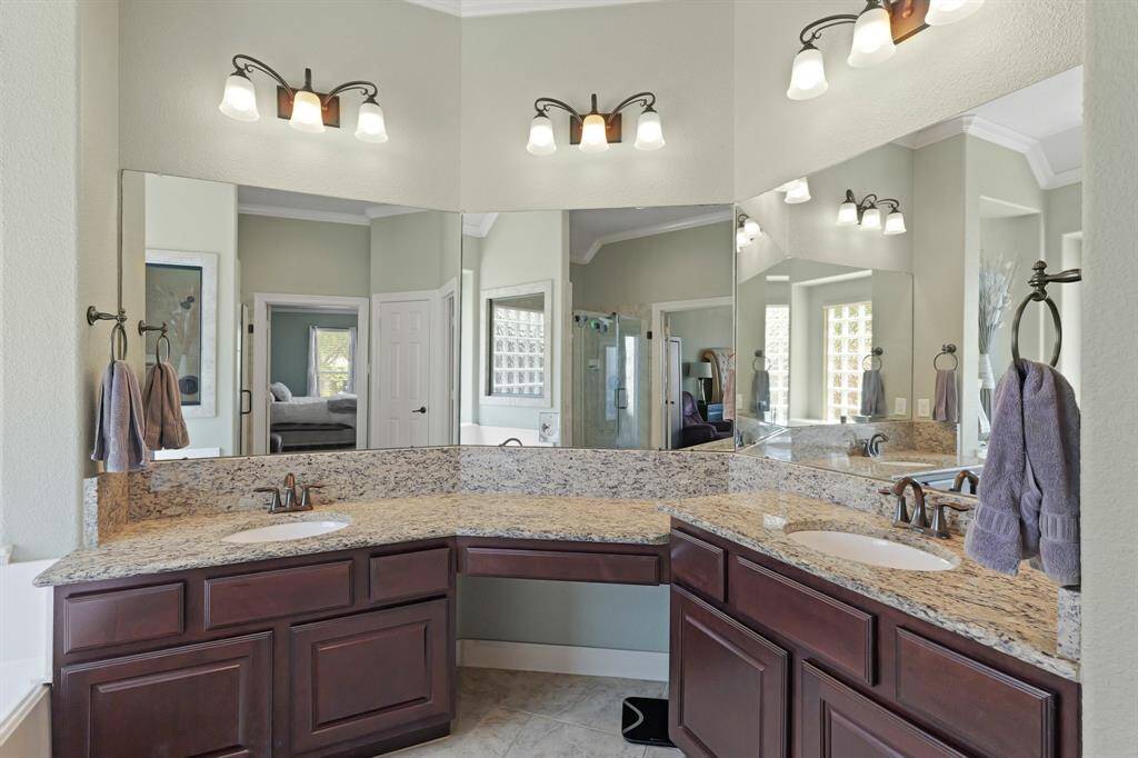 It is complete with  dual vanities, granite countertops, and abundant light.