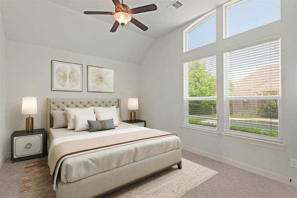 Virtually Staged: This grand secondary bedroom features carpet floors, a high ceiling with a ceiling fan, and windows with privacy blinds.