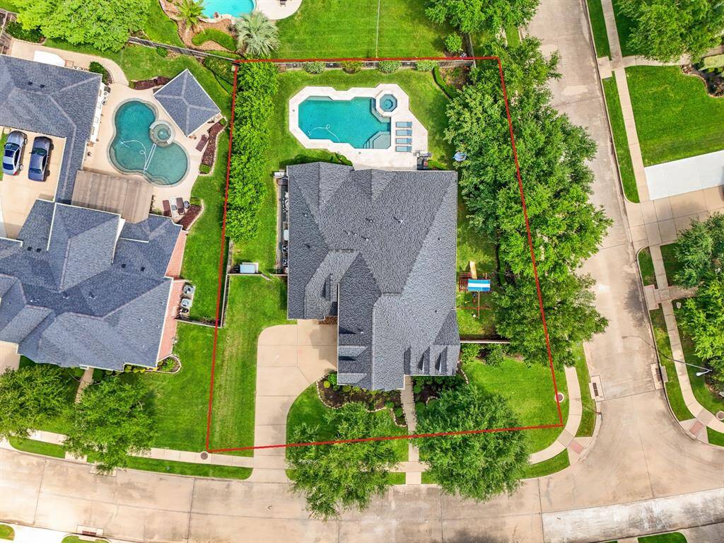 Bird’s-eye view of your private backyard oasis, complete with a pool, spa, and lush landscaping offering privacy and serenity.